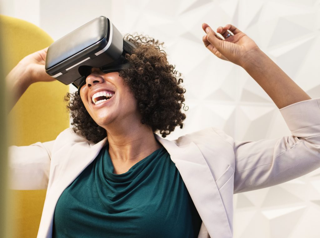 Joyful woman experiencing virtual reality training with a VR headset.