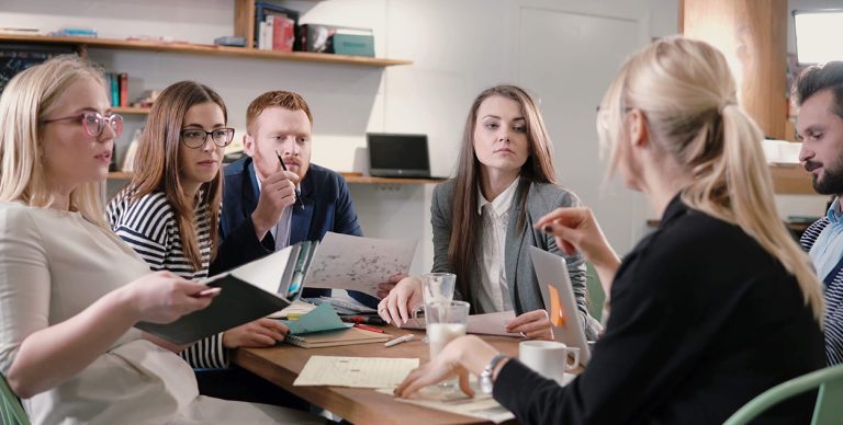 Team of business professionals having a serious discussion in a meeting room.